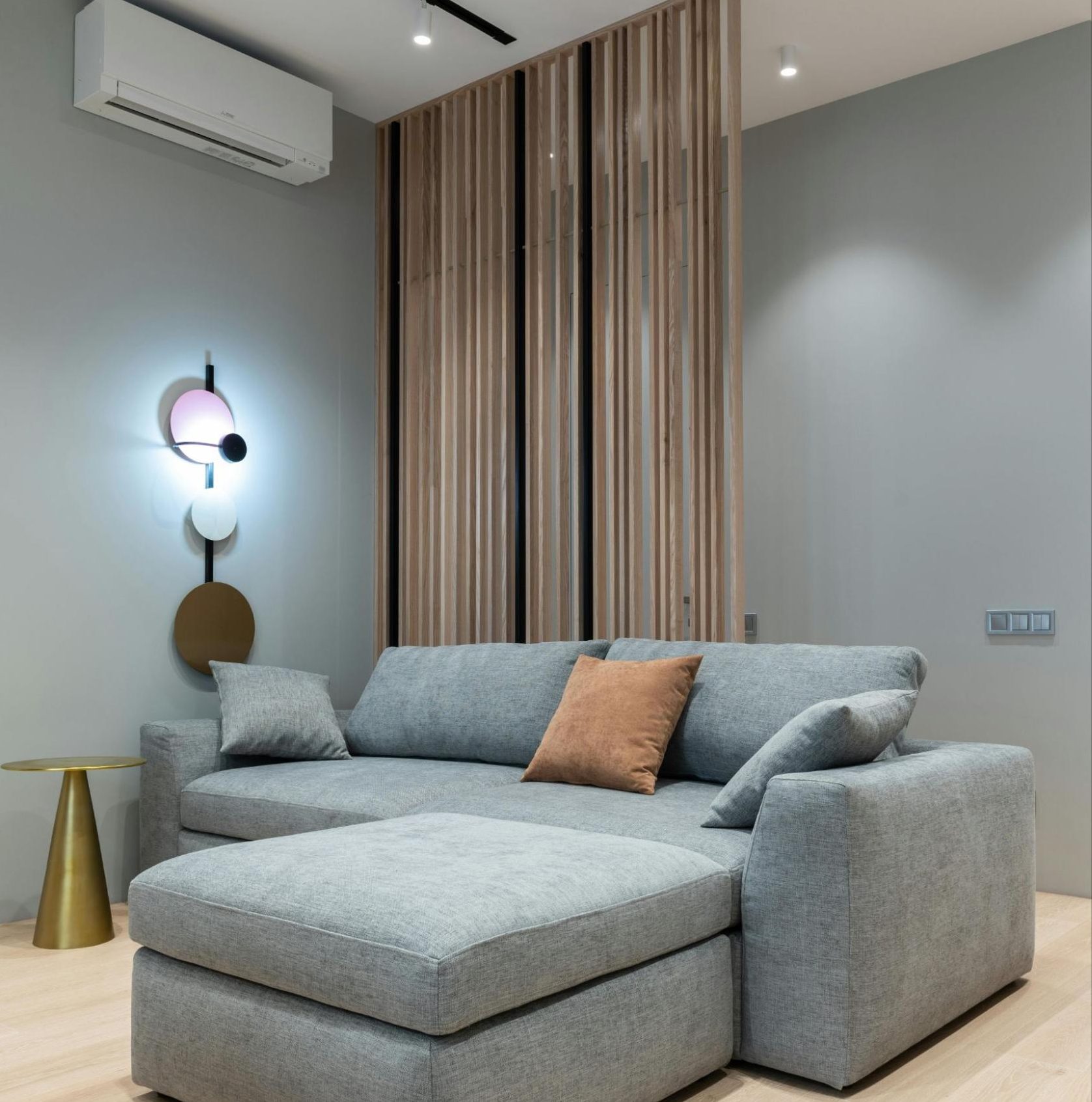 Ceiling-mounted HVAC unit circulating cool air throughout a spacious living room with modern decor.